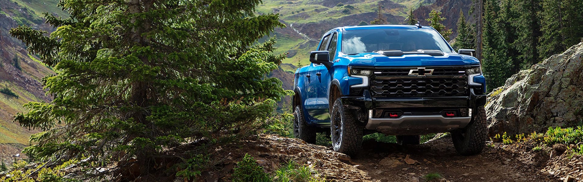 2022 Chevrolet Silverado 1500 climbing a rocky hill, demonstrating off-road strength and capability.